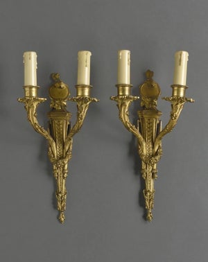 After Jean-Charles Delafosse (1734-1791). Pair of Louis XVI gilt bronze wall sconces