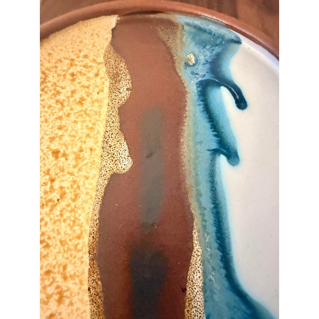 Beautiful set of three handcrafted graduated size studio pottery plates featuring expressive abstract glazing in earthy...