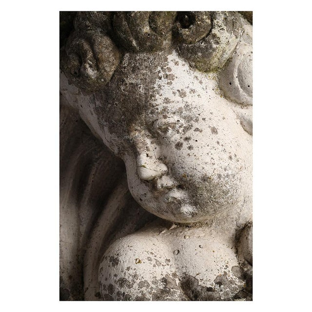Cement statue of Cupid. Cement sculpture. Represents Cupid. Ideal to place in a garden or indoors. This piece is designed...