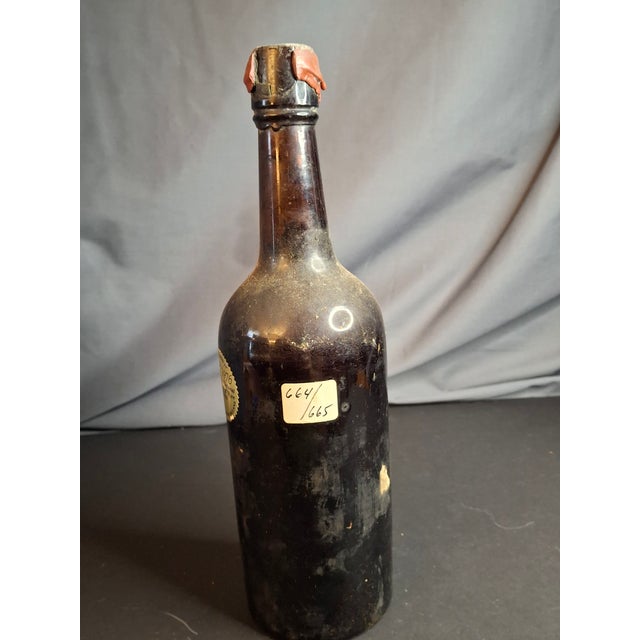 Note: This item is a 20th-century historical artifact: an empty wine bottle that carries documented provenance from the...