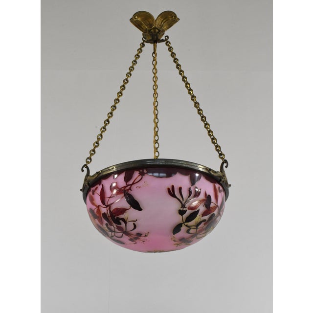 établissement Émile Gallé A French art deco pendant light in gild bronze with a Gallé bowl in acid-engraved cameo glass....