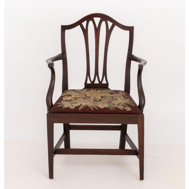 George III Style Mahogany Arm Chair, with openwork back splat and burgundy and floral needlepoint drop seat. 38" H x...