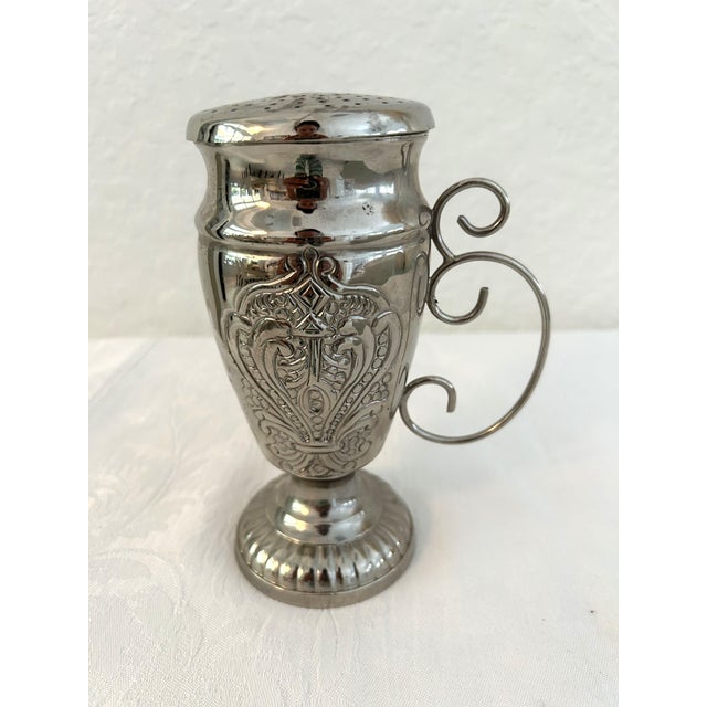 Gorgeous Victorian design handled powder shaker. Tarnish resistant nickel plated on brass shaker features an engraved...