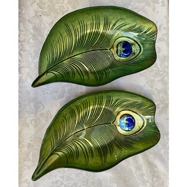 A rare pair of vintage mid century reverse painted Peacock Feather bowls just waiting to decorate your favorite table. A...