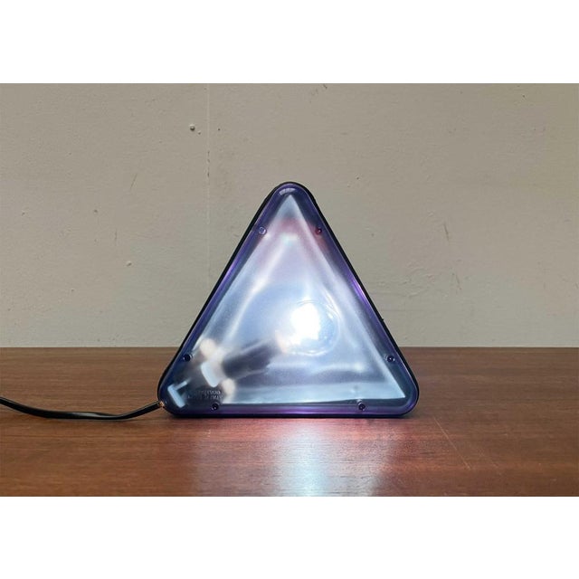 Triangular table lamp from the Italian manufacturer Ottika. A postmodern design in form and materiality. The lamp has the...