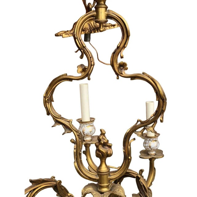 Approximately 29” wide 35” high 38” drop 12 light chandelier with ornate floral detail throughout the entire fixture with...
