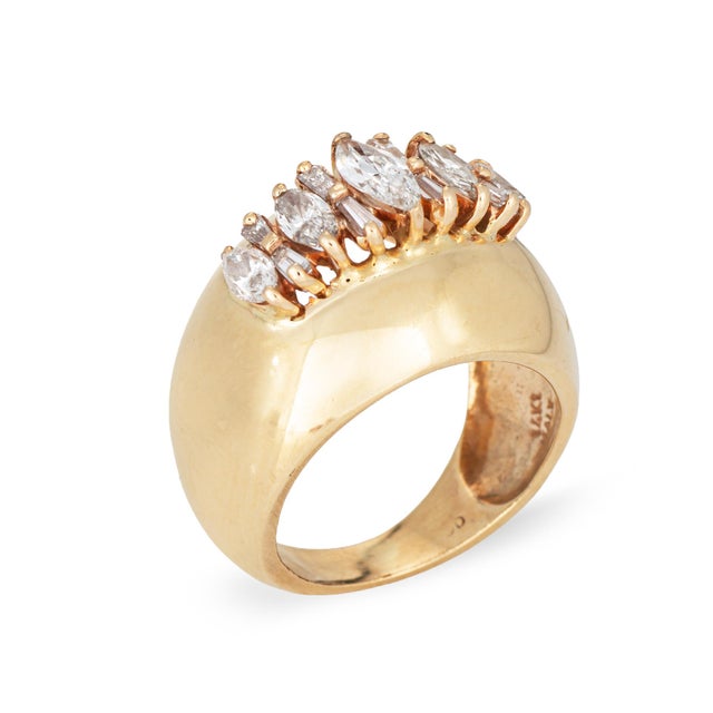 Stylish mixed cut diamond bombe ring (circa 1960s) crafted in 14k yellow gold. Marquise and tapered baguette diamonds...