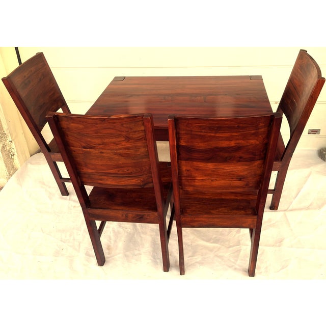 A unique set: a massive table and 4 chairs made of solid exotic wood, rosewood. The furniture features beautiful grain, a...