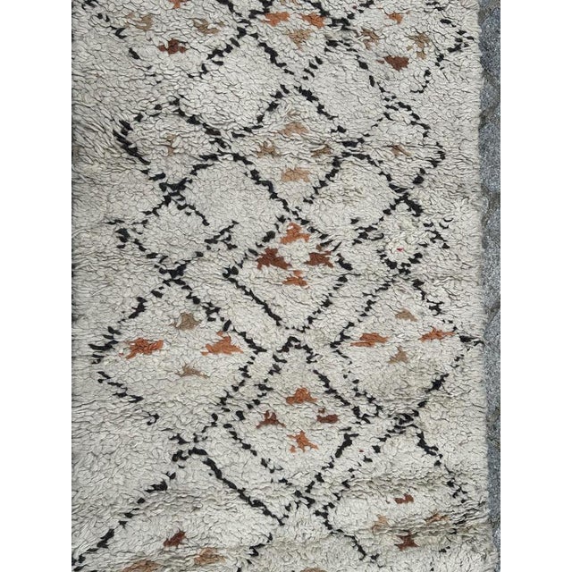 Nice mid century tribal Beni Ouarain Moroccan rug with a geometrical design and with field, orange, beige, brown and black...