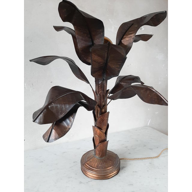 Vintage brass table lamp in the shape of a banana plant. This mid-century design lamp is inspired by the Maison Jansen...