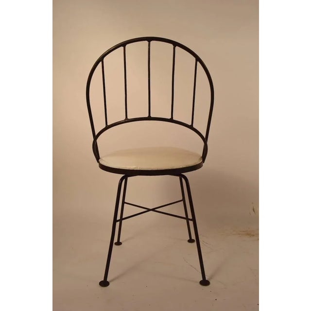 Four swivel chairs with wrought iron frames, and upholstered pad seats (upholstery as is). Interesting wraparound...