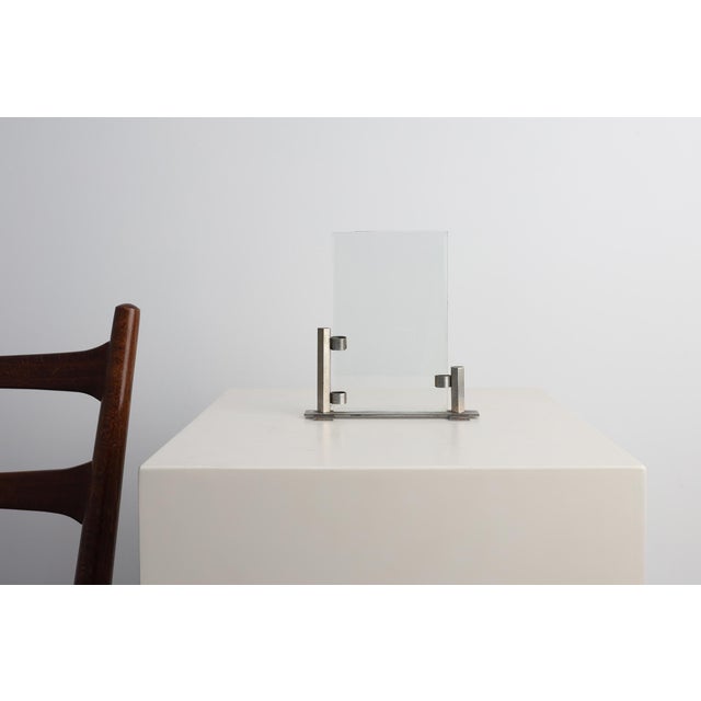 A sleek modernist photo frame from Belgium, dating to the early Art Deco period (circa 1920). The design combines...