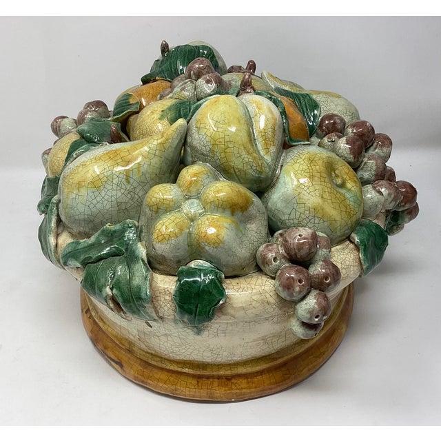 Majolica centerpiece in classic trompe l'oeil style, designed to look like a realistic, three-dimensional arrangement of...