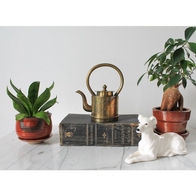 Vintage Chinese brass teapot with floral motif. Stamped "China" on bottom. Minor age wear.