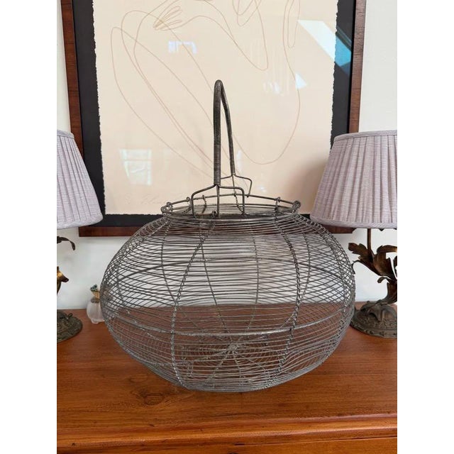 Exceptional very large wire egg basket.I shipped it home from Provence, France many years ago and it's happily lived in my...