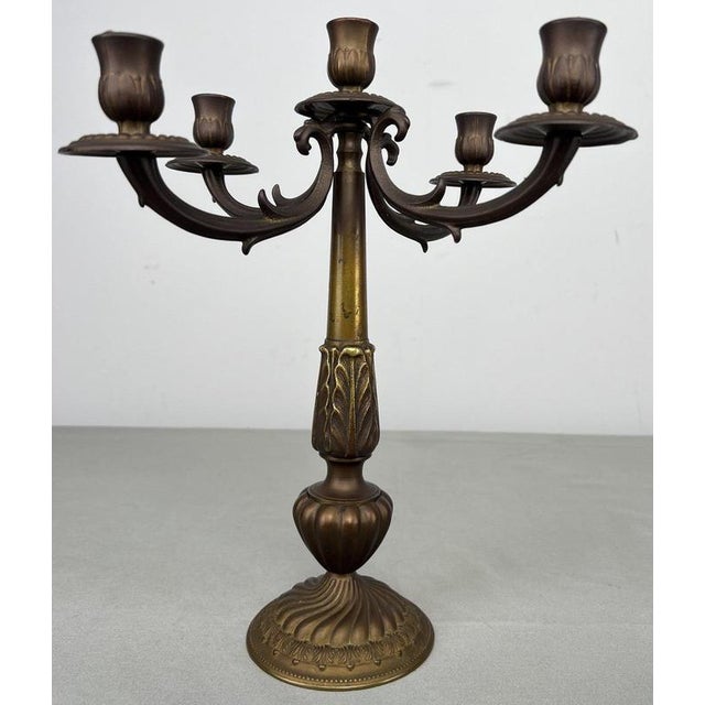 An elegant Vintage Italy candelabra featuring five sweeping arms and highly decorative detailing throughout, with an...