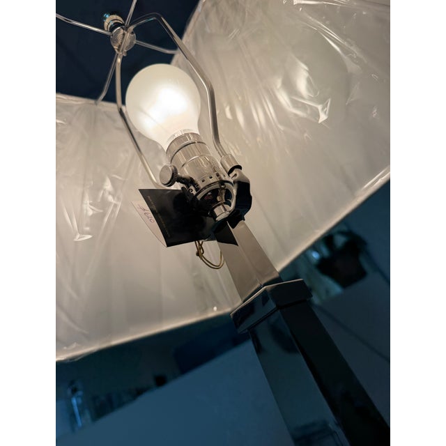 A Haig table lamp featuring a brass plated-nickel finish with a tapered square column base. Completed with an off-white...