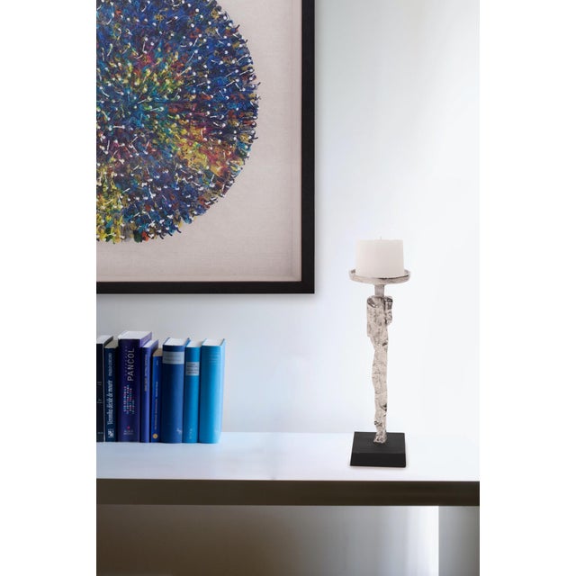 Hand sketches of human silhouettes on a napkin were transformed into a cast aluminum base for this candle holder. Finished...