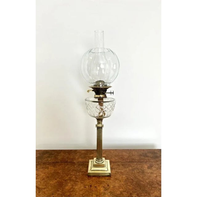 Lovely antique Victorian quality brass oil lamp having a clear glass shaped shade, transparent cut glass reservoir...