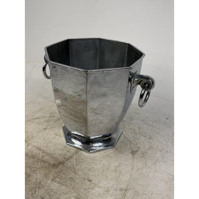 An elegant bucket with geometric lines, perfect for decorating or serving a classy bar. Crafted from polished chrome-...