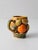 A vintage Inarco fruit mug featuring a richly detailed basket design layered with dimensional citrus and leaves. The...