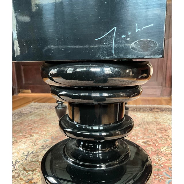 Originally purchased through Moss,New York, this sculptural table features a black lacquered base paired with a 5/8’’...
