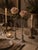 An elegant and refined pair of antique bud vases, each combining a slender etched glass tube with a weighted sterling...