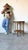 Beautiful vintage coastal end table by Palecek featuring a hand-crafted rattan and woven wicker frame with a round glass...