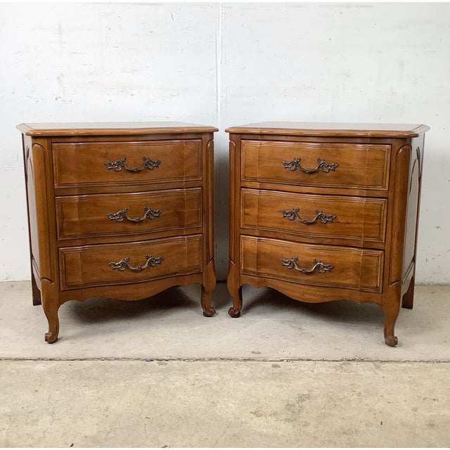 Elevate your home with this exquisite pair of vintage French Provincial three-drawer chests crafted by Davis Furniture...