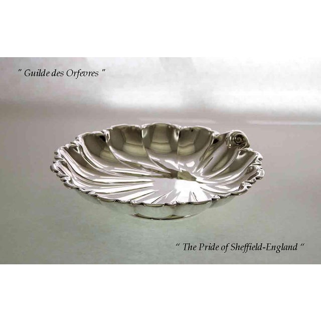 Ref # D 4091 Photo 257 Description: Silver Shell Shape Cake or Macaron Dish Pattern : Shell - Size : 8 in. A Silver Shell...