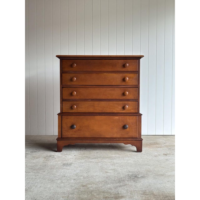 This vintage five-drawer dresser features a clean transitional silhouette with softly rounded edges, paneled sides, and...
