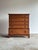 This vintage five-drawer dresser features a clean transitional silhouette with softly rounded edges, paneled sides, and...