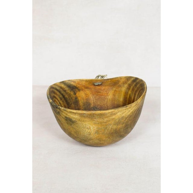 This hand-carved wooden bowl is made by the Turkana, a nomadic community in north-west Kenya prized for their woodcarving...