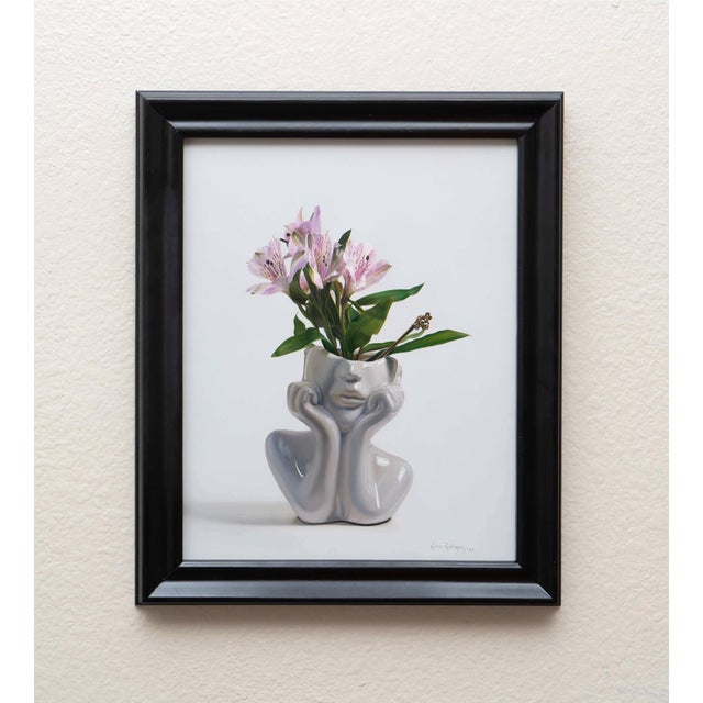 This artwork features a delicate arrangement of pink alstroemeria flowers, their intricate petals and subtle variations in...