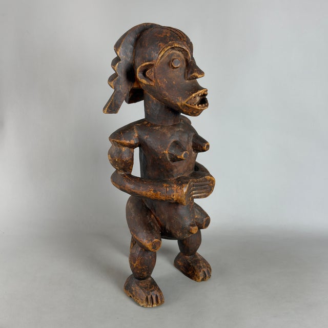 An imposing and mesmerizing solid wood ritual altar statue, attributed to traditional 20th-century Central West African...