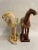 These diminutive tang style horses are a perfect pair to style a shelf or table top. They are everything a tang horse...