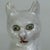 A rare to market pair of vintage French white tin glazed terracotta figurines of green glass eyed cats. One is stamped...