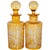 A fine pair of antique 19th century Bohemian hand-etched amber colored glass wine or liquor decanters and stoppers,...
