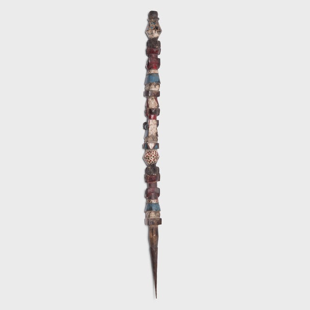 Hand-carved with a figurative design, this totem-like wooden post was crafted by an artisan of the Yoruba peoples of...