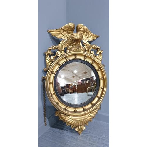 This is a superb example of a English water gilded wall mirror with eagle top, slightly convexted mirror with black reeded...