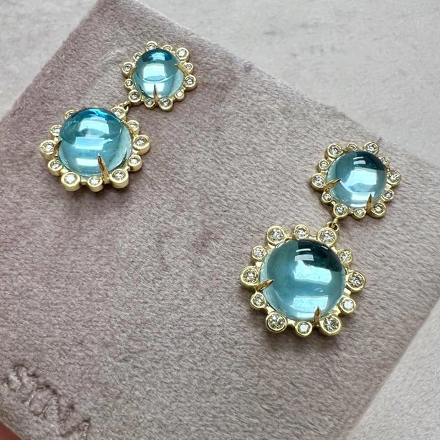 Created in 18 karat yellow gold Blue Topaz 21 carats approx. Diamonds 0.80 carat approx. Post back for pierced ears...