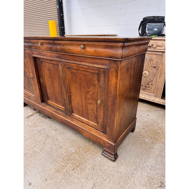 This 19th-century Louis Philippe French server exudes timeless elegance with its ornate craftsmanship and rich walnut...