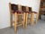 A striking set of three vintage Southwestern bar stools featuring solid rustic log construction and distinctive...