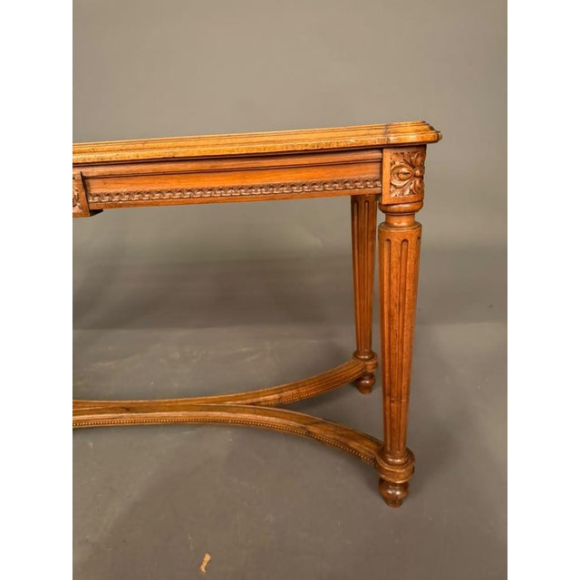 An elegant 19th-century French walnut and cane bench, circa 1880, featuring a beautifully hand-caned seat, intricate...