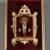 Statue of the Madonna and Child in silver-plated metal mounted on a gilded and white lacquered wooden frame. Garnet red...