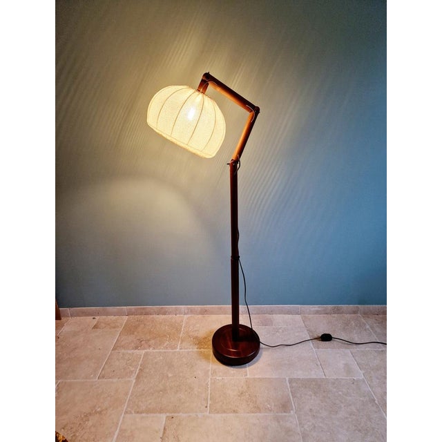 Scandinavian teak floor lamp with a openwork fabric lampshade, 70s The articulated arm allows you to change the position...