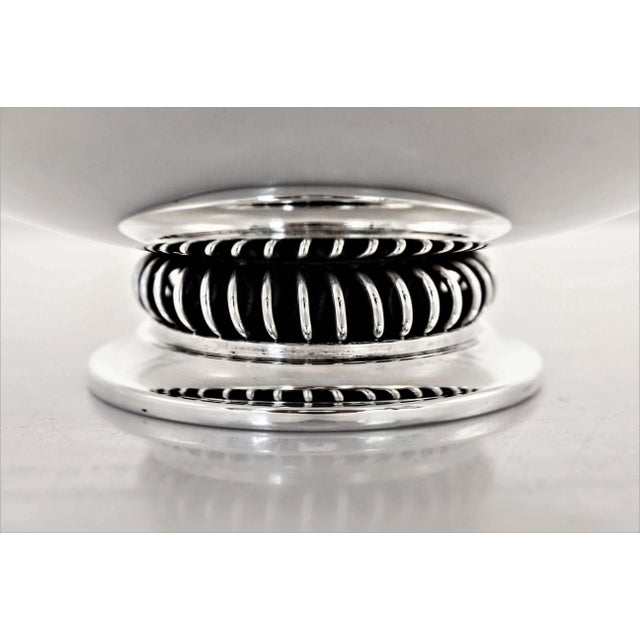 Danish silversmiths are known for their uber-modern hollowware and here’s an example. There are no decorations or designs...