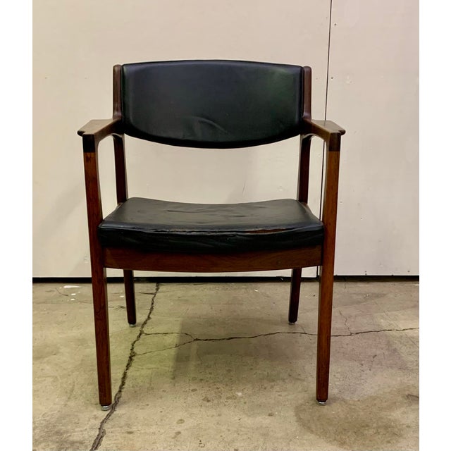 Rosewood Armchair in the style of Erik Buch. That’s a super solid chair made out of pure rosewood not a rosewood veneer.