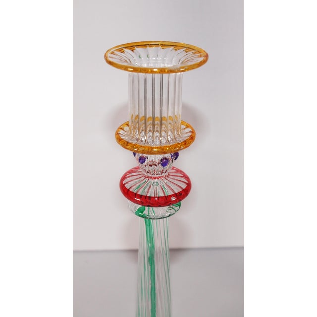 Pair of Murano attributed multicolored glass candlesticks. Starts with gold top rim, purple dots, red disk and green...