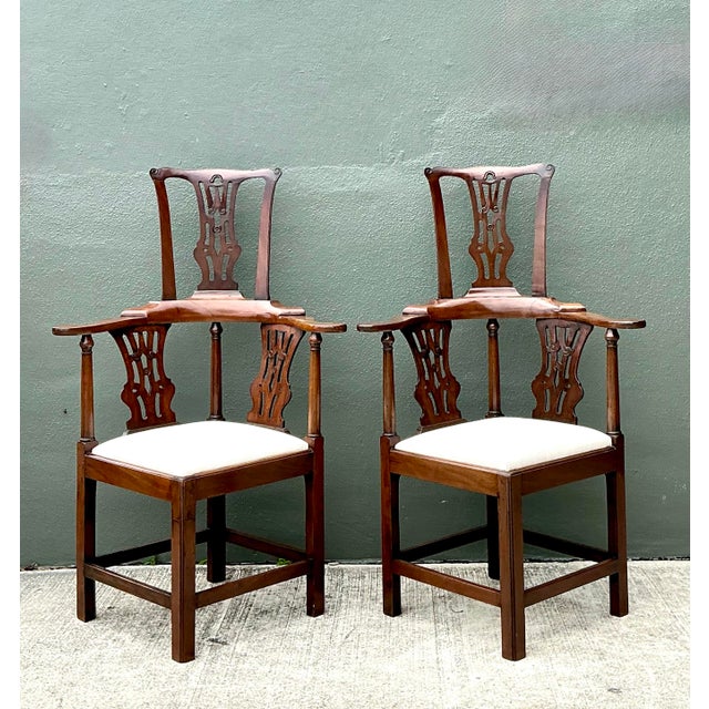 Elevate your interior with this exceptional pair of Chippendale style high-back corner chairs. These pieces showcase a...